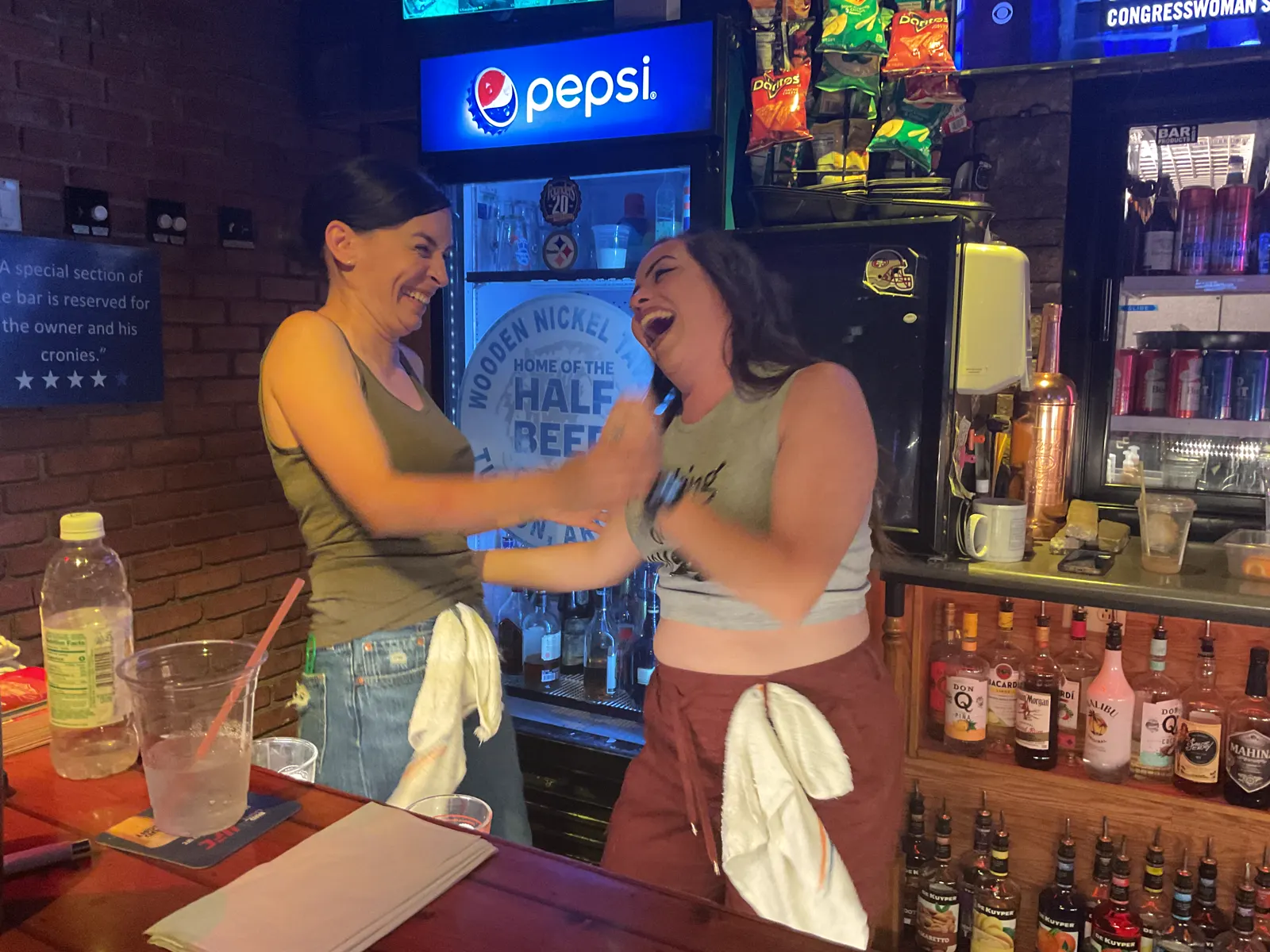 Friends singing a karaoke duet at the bar
