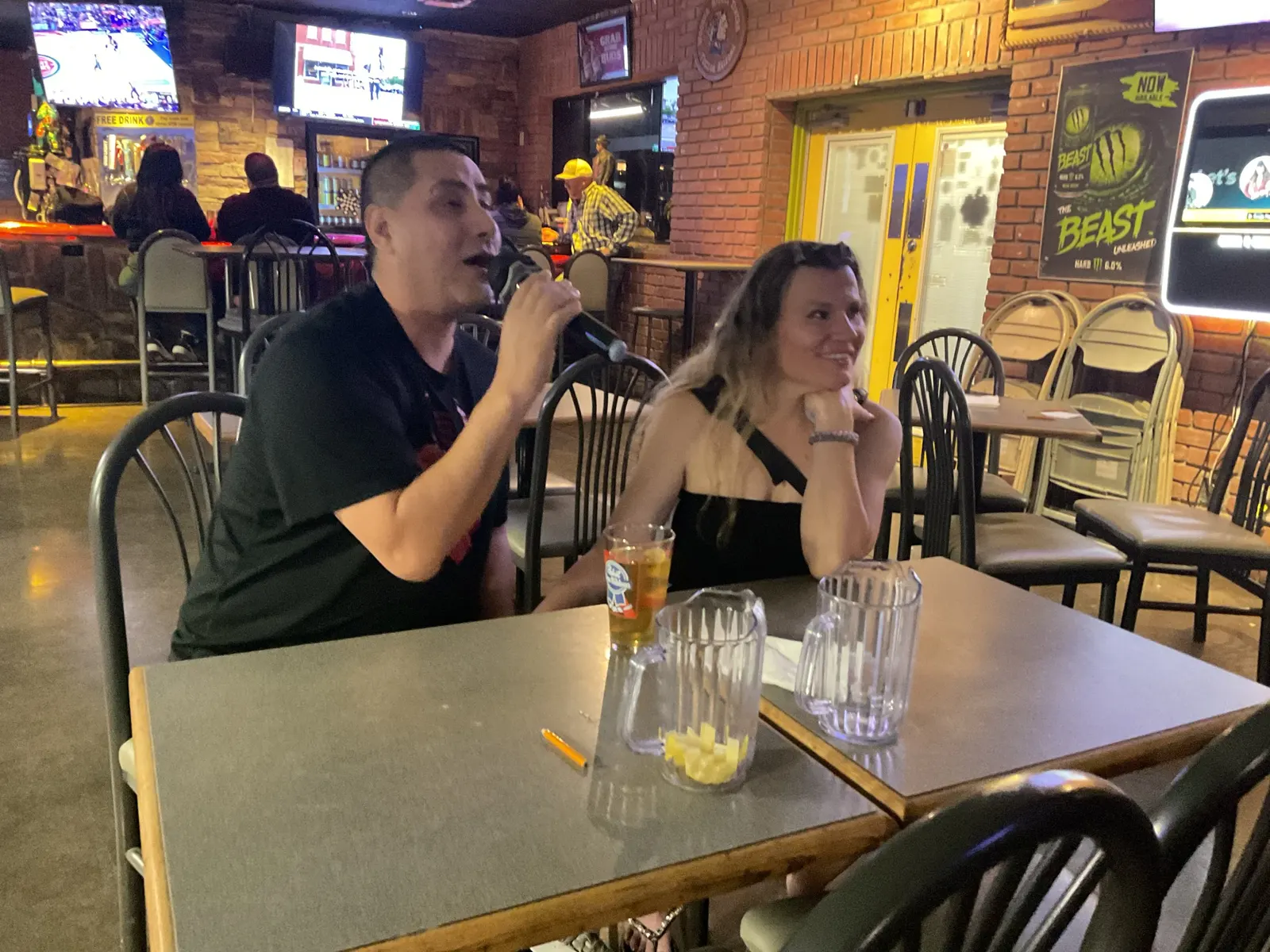 Two customers singing karaoke together