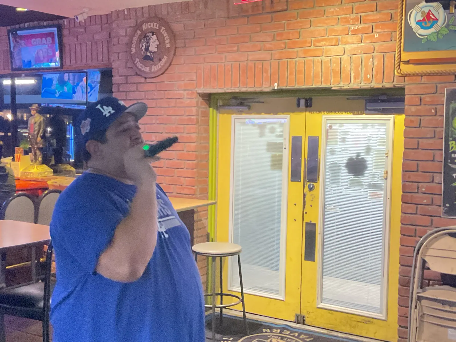 Man singing karaoke inside the tavern