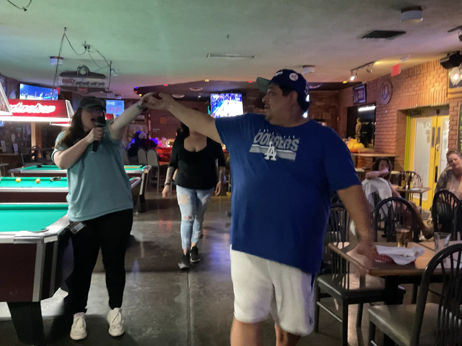 Singer and audience during karaoke at Wooden Nickel Tavern
